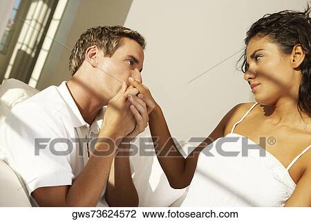 Side profile of a young man kissing a young woman's hand View Large Photo Image Stock Image - Side profile of a young man kissing a young woman's hand. Fotosearch