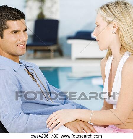 Side profile of a young woman and a mid adult man smiling View Large Photo Image Stock Image - Side profile of a young woman and a mid adult man smiling. Fotosearch