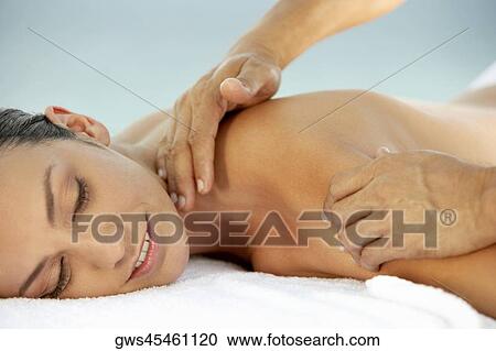 Side profile of a young woman getting a shoulder massage View Large Photo Image Stock Image - Side profile of a young woman getting a shoulder massage. Fotosearch