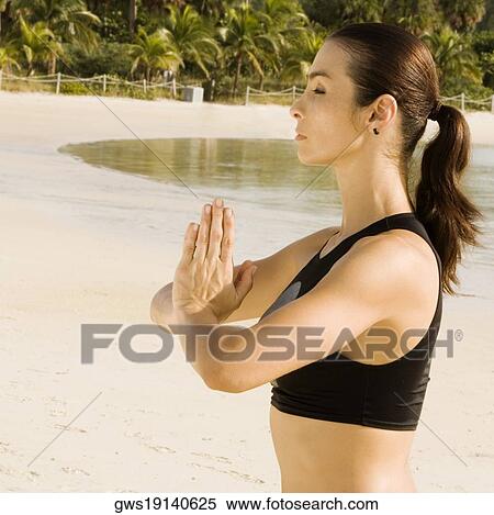 Side profile of a young woman in a prayer position View Large Photo Image Stock Photography - Side profile of a young woman in a prayer position. Fotosearch