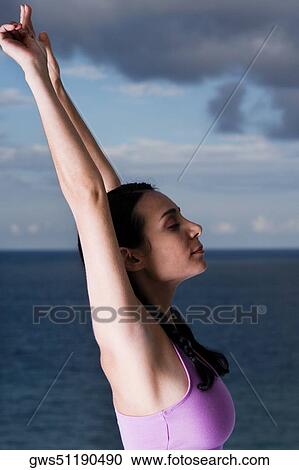 Side profile of a young woman meditating View Large Photo Image Stock Image - Side profile of a young woman meditating. Fotosearch
