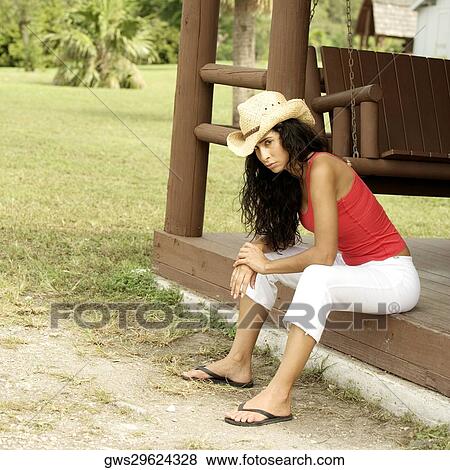 Side profile of a young woman sitting on the ledge View Large Photo Image Stock Photo - Side profile of a young woman sitting on the ledge. Fotosearch