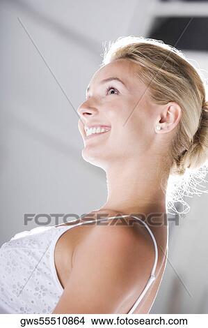 Side profile of a young woman smiling View Large Photo Image Picture - Side profile of a young woman smiling. Fotosearch