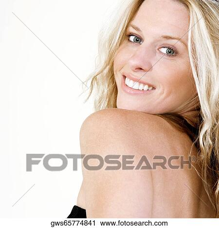 Side profile of a young woman smiling View Large Photo Image Stock Image - Side profile of a young woman smiling. Fotosearch