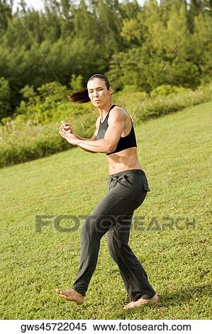 Side profile of a young woman practicing martial arts View Large Photo Image Stock Photography - Side profile of a young woman practicing martial arts. Fotosearch