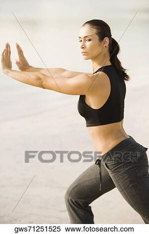 Side profile of a young woman practicing martial arts on the beach View Large Photo Image Stock Photography - Side profile of a young woman practicing martial arts on the beach. Fotosearch