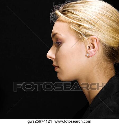 Stock Image - Side profile of a young woman thinking. Fotosearch