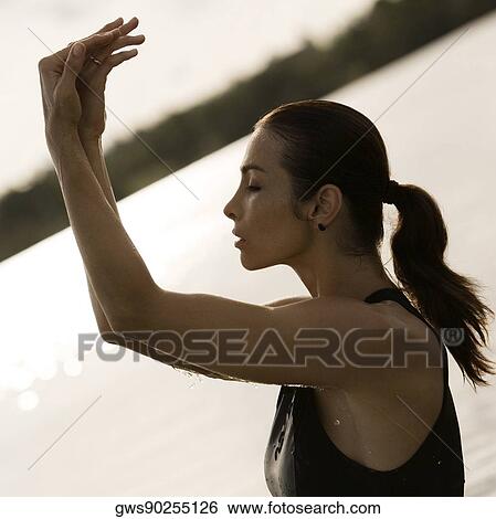 Side profile of a young woman with her eyes closed View Large Photo Image Stock Photograph - Side profile of a young woman with her eyes closed. Fotosearch