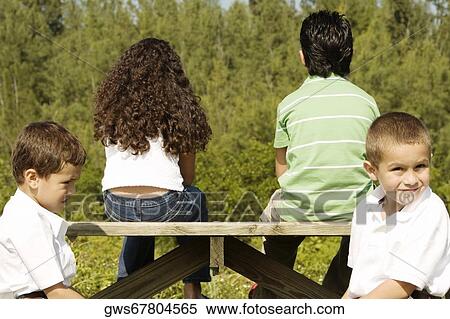 Side profile of two boys sitting together View Large Photo Image Stock Photography - Side profile of two boys sitting together. Fotosearch