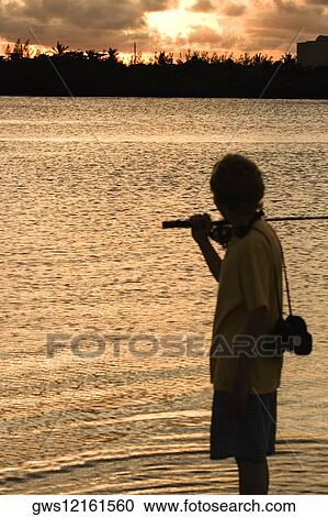 Silhouette of a boy carrying a fishing rod View Large Photo Image Stock Image - Silhouette of a boy carrying a fishing rod. Fotosearch