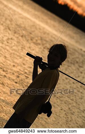 Silhouette of a boy carrying a fishing rod View Large Photo Image Stock Image - Silhouette of a boy carrying a fishing rod. Fotosearch