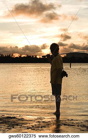 Silhouette of a boy carrying a fishing rod View Large Photo Image Stock Photography - Silhouette of a boy carrying a fishing rod. Fotosearch