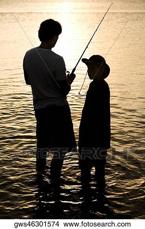 Picture - Silhouette of a father and his son fishing. Fotosearch
