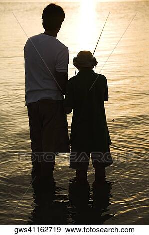 Silhouette of a father and his son fishing View Large Photo Image Stock Photo - Silhouette of a father and his son fishing. Fotosearch