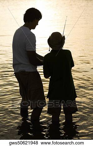 Stock Photo - Silhouette of a father and his son fishing. Fotosearch
