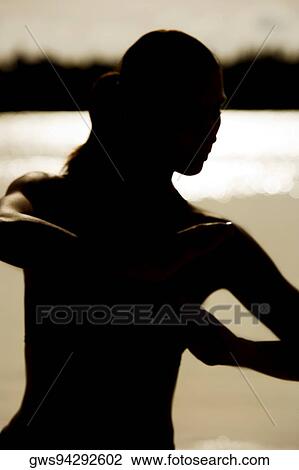 Silhouette of a young woman practicing martial arts on the beach View Large Photo Image Stock Image - Silhouette of a young woman practicing martial arts on the beach. Fotosearch