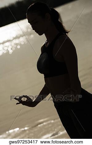 Stock Photo - Silhouette of a young woman practicing martial arts. Fotosearch