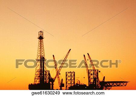 Silhouette of an oil rig, Tunisia, Africa View Large Photo Image Stock Photo - Silhouette of an oil rig, Tunisia, Africa. Fotosearch
