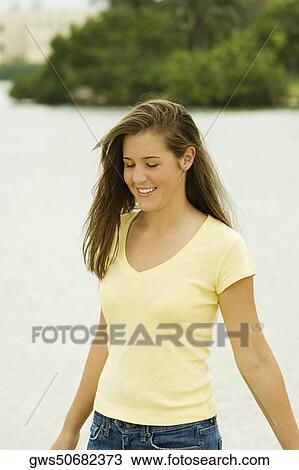 Teenage girl standing on the beach View Large Photo Image Stock Image - Teenage girl standing on the beach. Fotosearch