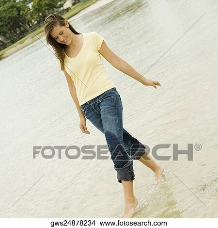 Teenage girl walking on the beach View Large Photo Image Picture - Teenage girl walking on the beach. Fotosearch