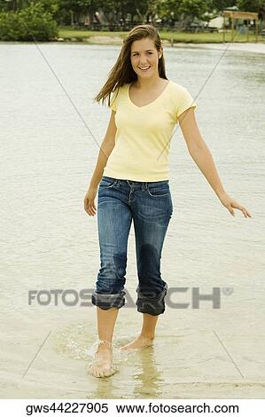 Teenage girl walking on the beach View Large Photo Image Stock Photography - Teenage girl walking on the beach. Fotosearch