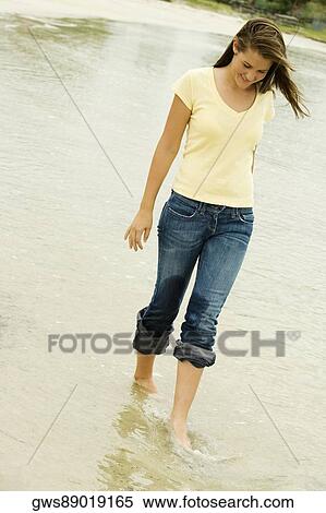 Teenage girl walking on the beach looking down View Large Photo Image Stock Photography - Teenage girl walking on the beach looking down. Fotosearch