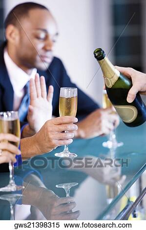 Three people sitting at a bar counter holding champagne flutes View Large Photo Image Stock Photography - Three people sitting at a bar counter holding champagne flutes. Fotosearch