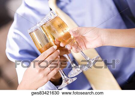Three people toasting with champagne flutes View Large Photo Image Stock Image - Three people toasting with champagne flutes. Fotosearch