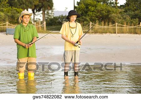 Two boys fishing in a lake View Large Photo Image Stock Image - Two boys fishing in a lake. Fotosearch