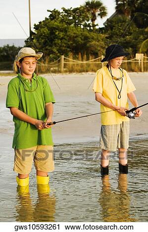 Stock Image - Two brothers fishing in a lake. Fotosearch