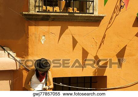 Woman sitting outside a building, Mexico View Large Photo Image Stock Photography - Woman sitting outside a building, Mexico. Fotosearch