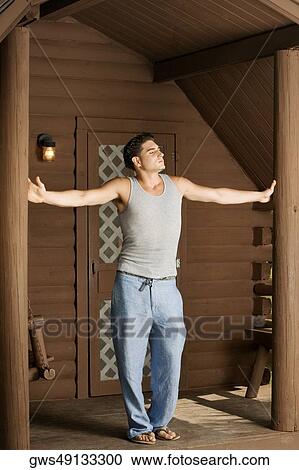 Young man standing with his arms outstretched View Large Photo Image Stock Image - Young man standing with his arms outstretched. Fotosearch