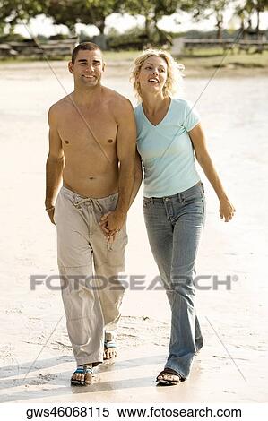 Young man walking with a young woman View Large Photo Image Stock Photography - Young man walking with a young woman. Fotosearch
