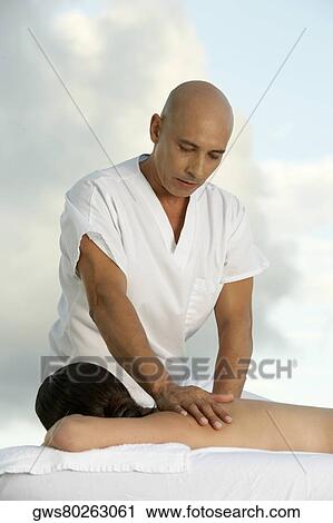 Young woman getting a back massage from a mature man View Large Photo Image Stock Image - Young woman getting a back massage from a mature man. Fotosearch