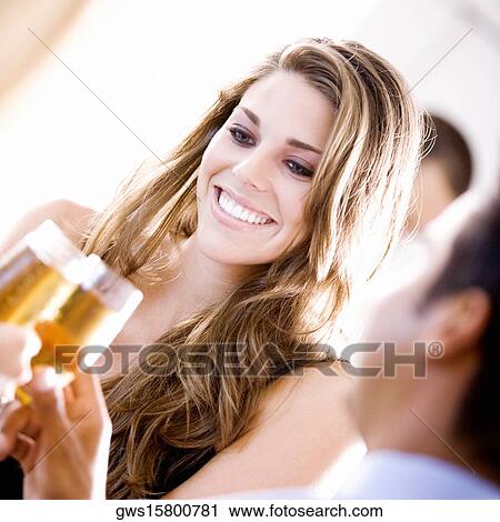 Young woman holding a glass of champagne View Large Photo Image Stock Image - Young woman holding a glass of champagne. Fotosearch