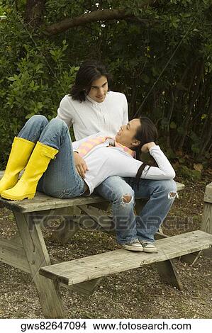 Young woman lying on a young man's lap View Large Photo Image Picture - Young woman lying on a young man's lap. Fotosearch