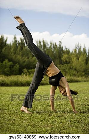 Stock Photo - Young woman practicing martial arts. Fotosearch