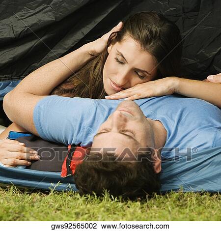 Young woman resting her head on a mid adult man's chest View Large Photo Image Stock Image - Young woman resting her head on a mid adult man's chest. Fotosearch