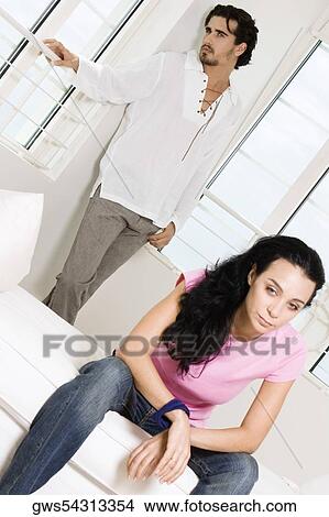 Young woman sitting with a young man standing behind her View Large Photo Image Picture - Young woman sitting with a young man standing behind her. Fotosearch