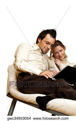 Businessman and a businesswoman reclining on a chaise lounge with a laptop in front of them View Large Photo Image Picture - Businessman and a businesswoman reclining on a chaise lounge with a laptop in front of them. Fotosearch