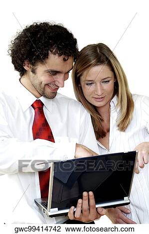 Businessman and a businesswoman using a laptop View Large Photo Image Stock Image - Businessman and a businesswoman using a laptop. Fotosearch