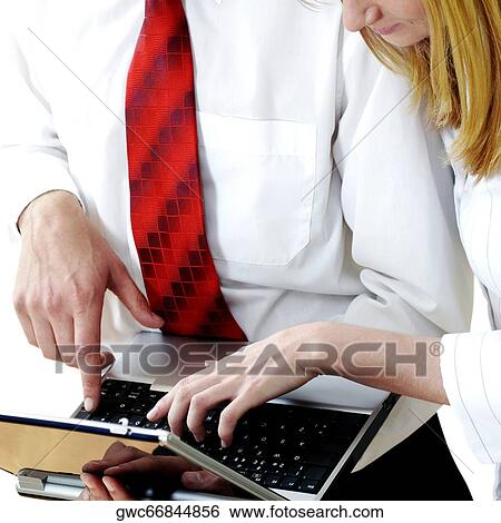 Businessman and a businesswoman using a laptop View Large Photo Image Stock Photograph - Businessman and a businesswoman using a laptop. Fotosearch