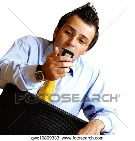 Businessman looking at a mobile phone View Large Photo Image Stock Image - Businessman looking at a mobile phone. Fotosearch