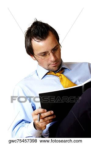 Businessman reading a notebook View Large Photo Image Stock Photo - Businessman reading a notebook. Fotosearch