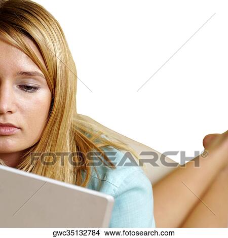 Businesswoman looking at a laptop View Large Photo Image Picture - Businesswoman looking at a laptop. Fotosearch
