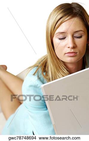 Businesswoman lying in front of a laptop View Large Photo Image Picture - Businesswoman lying in front of a laptop. Fotosearch
