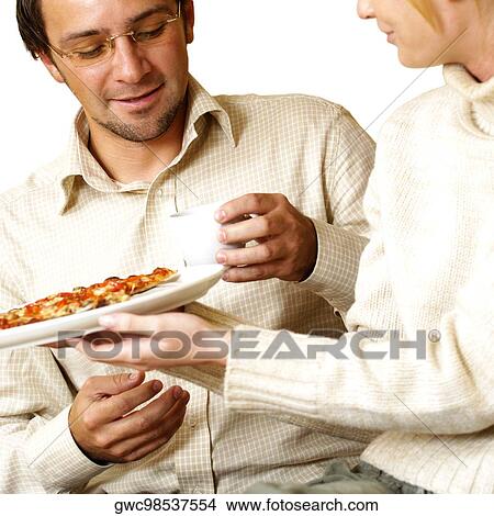 Businesswoman offering pizza to a businessman View Large Photo Image Picture - Businesswoman offering pizza to a businessman. Fotosearch