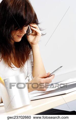 Businesswoman talking on a mobile phone View Large Photo Image Stock Image - Businesswoman talking on a mobile phone. Fotosearch