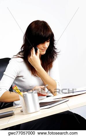 Stock Image - Businesswoman talking on a mobile phone. Fotosearch
