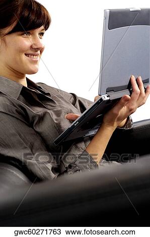 Stock Image - Businesswoman working on a laptop. Fotosearch